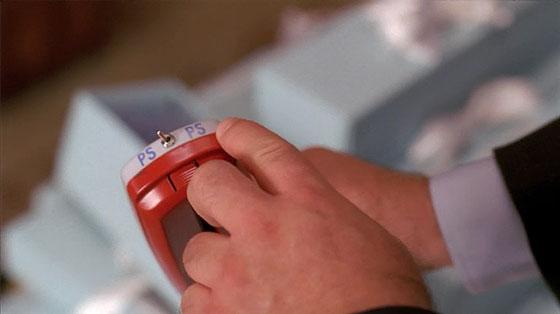 Still frame of Alec Baldwin's character, Jack Donaghy, holding a hand-held photo scanner/paper shredder, from the television show "30 Rock".